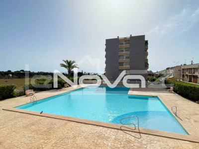 Apartment with 2 bedrooms and a terrace with side sea views 200 m from the beach in Punta Prima.